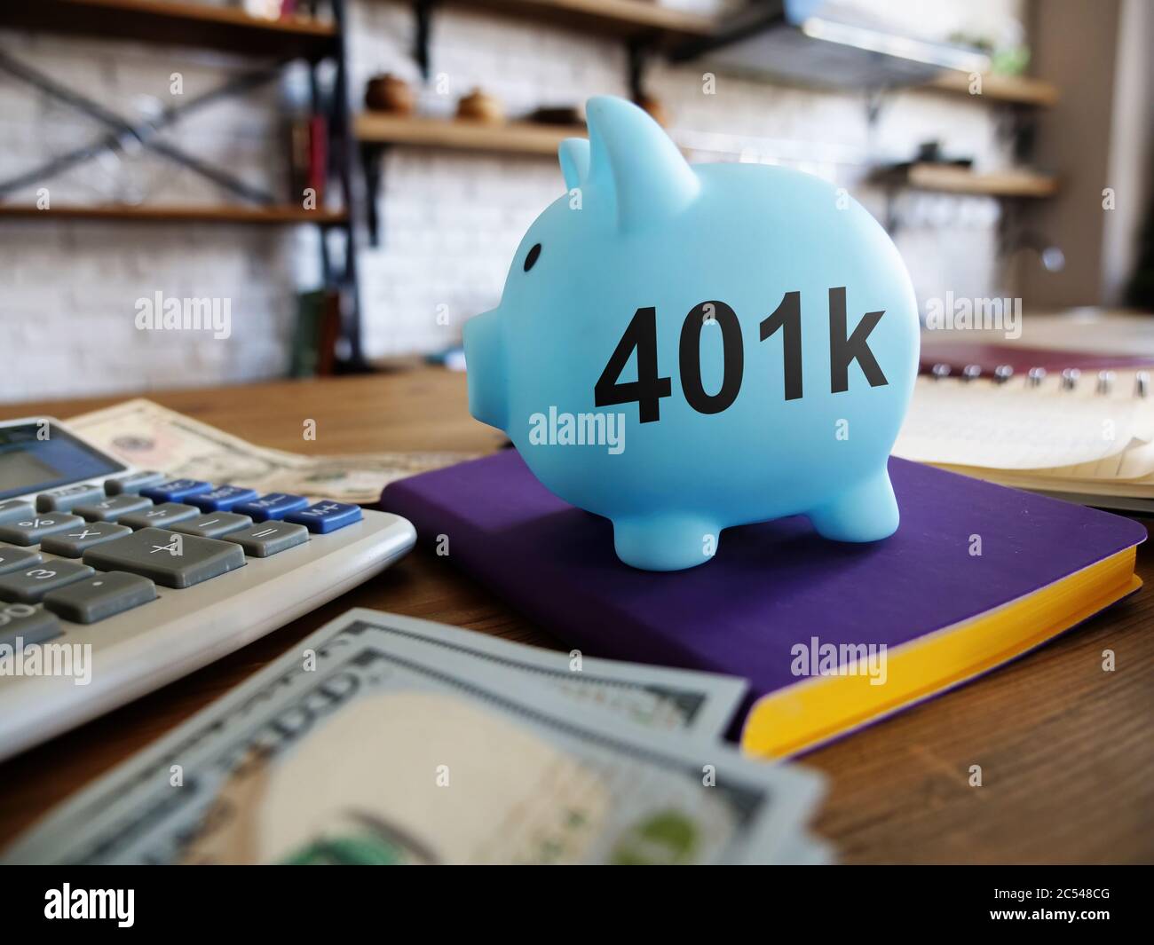 401k pension plan concept. Piggy bank and money at the kitchen. Stock Photo