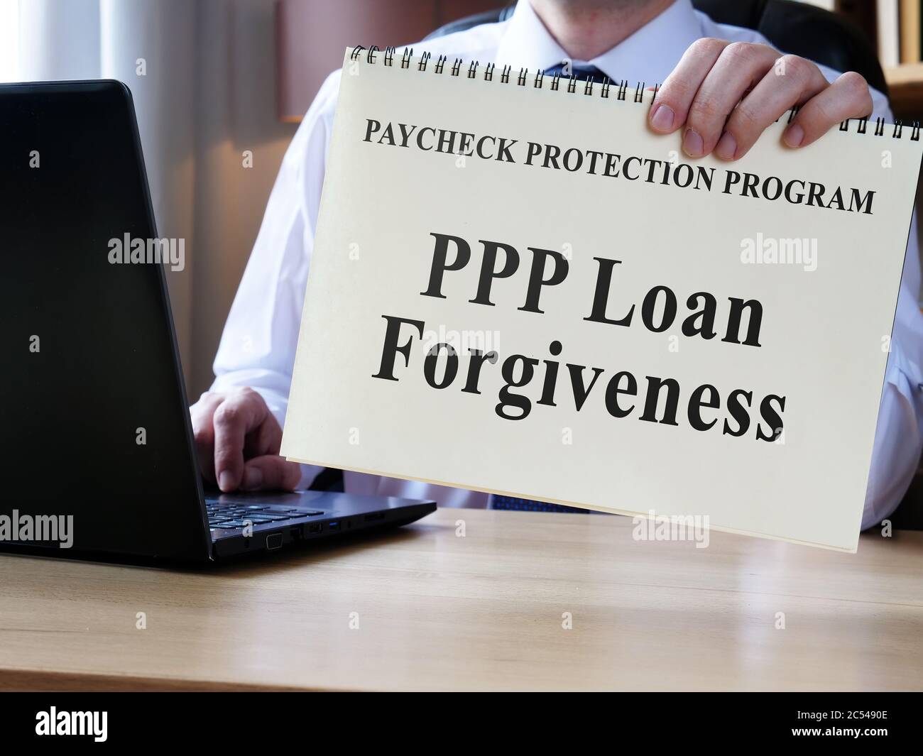 Accountant shows form for PPP loan forgiveness. Stock Photo