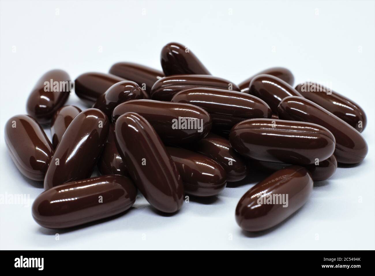 The dark brown gel vitamin pills spill on tabel Stock Photo Alamy