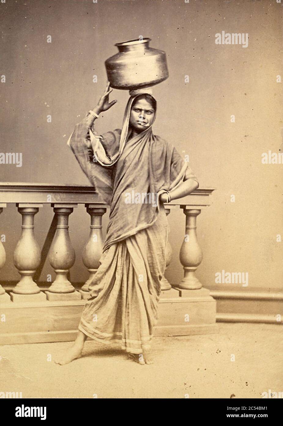 Indian woman with a metal water vessel on head in 1873. Stock Photo