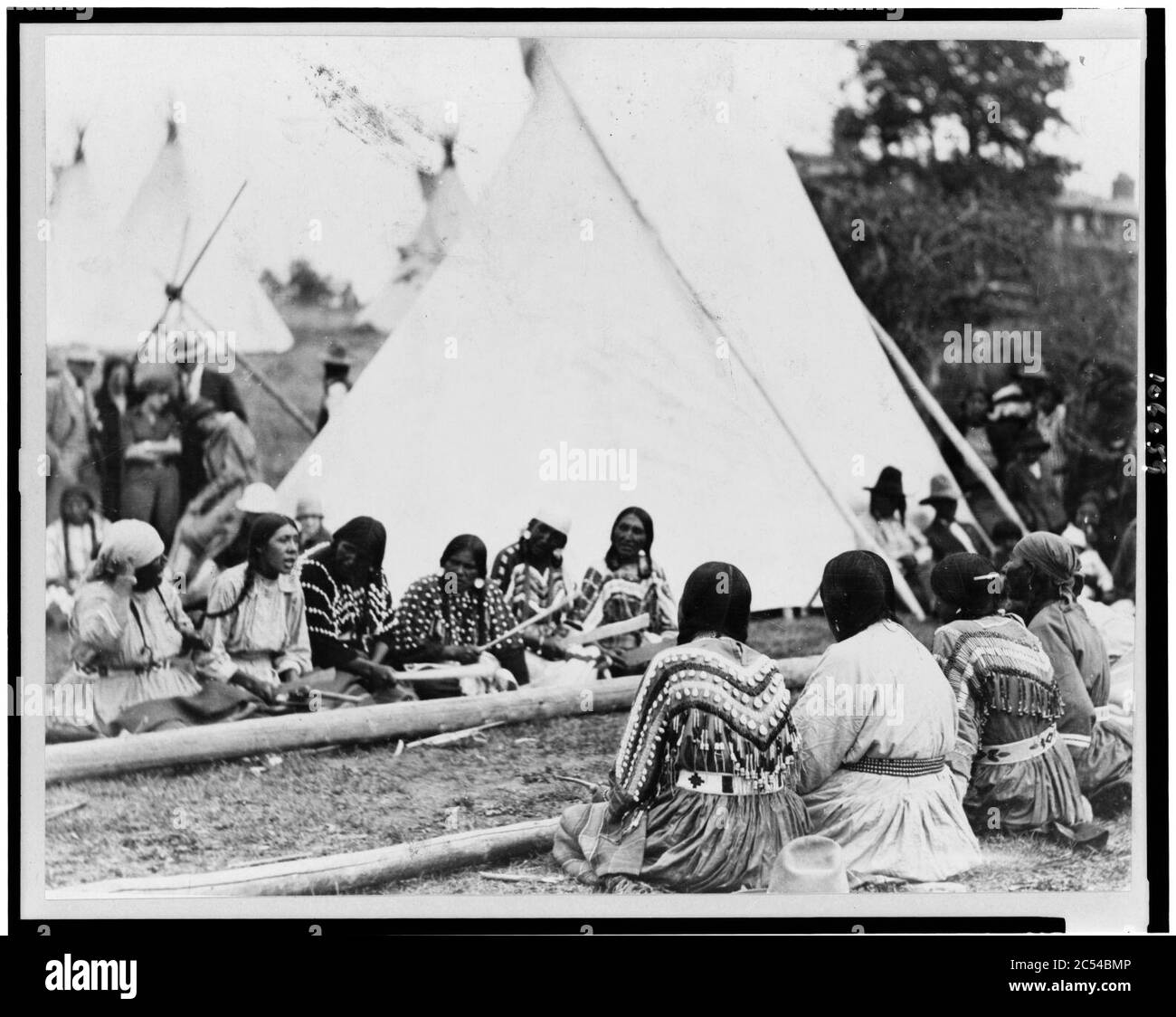 Indian women playing the stick game at the midsummer celebration on the Glacier National Park Reservation, Montana Stock Photo