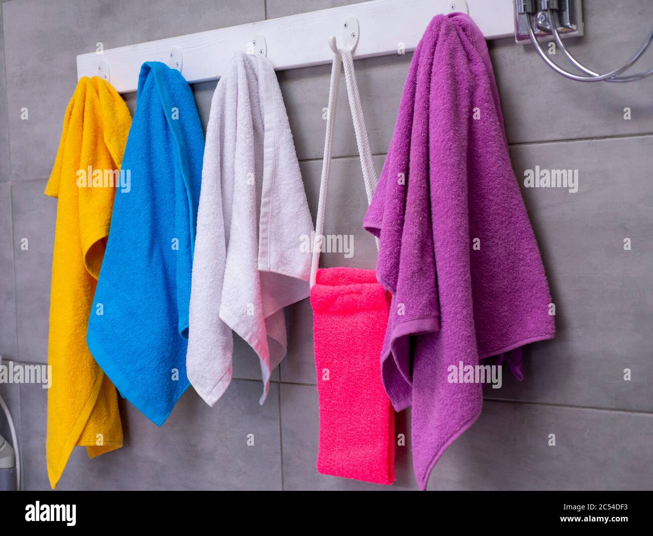 Colored towels blue, orange, pink and white are weighed in the Stock Photo Alamy