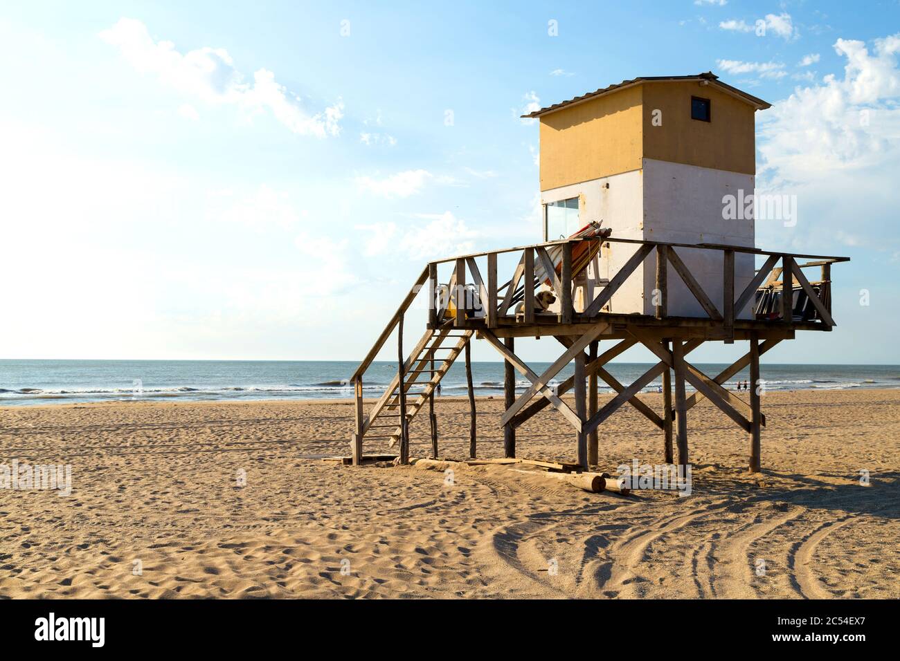 Beach scene. Lifeguard tower in foreground. Beautiful morning of summer. The sun bright over the sea. Mar de las Pampas, Argentina. Stock Photo