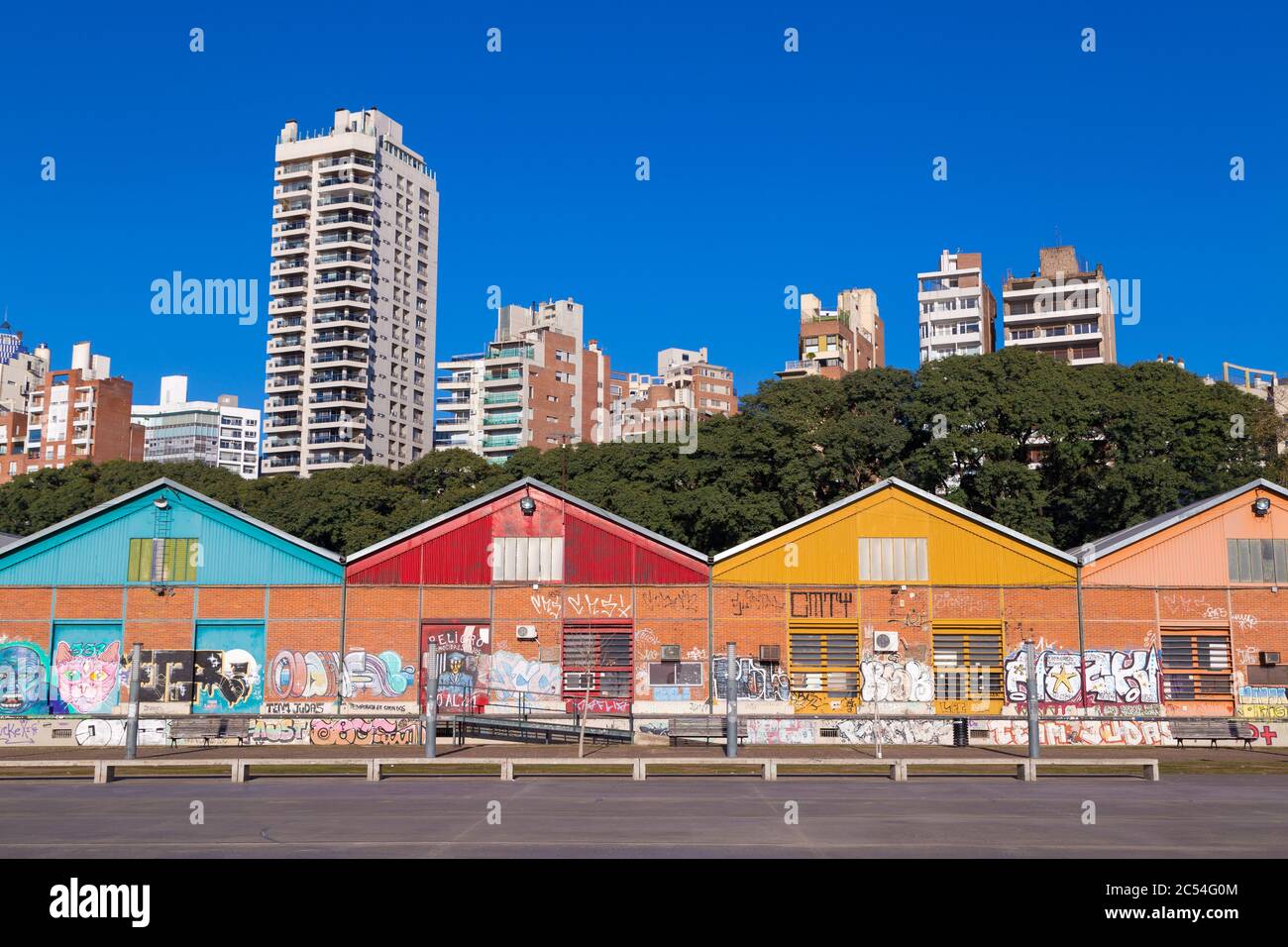 City of Rosario, Argentina. View of the colorful sheds of CEC in downtown next to the coast of Parana River. Buildings and trees at the background. Stock Photo