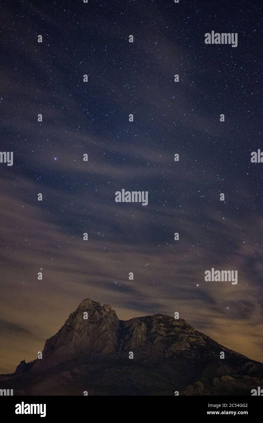Vertical shot of the night sky full of stars over the rocks Stock Photo ...