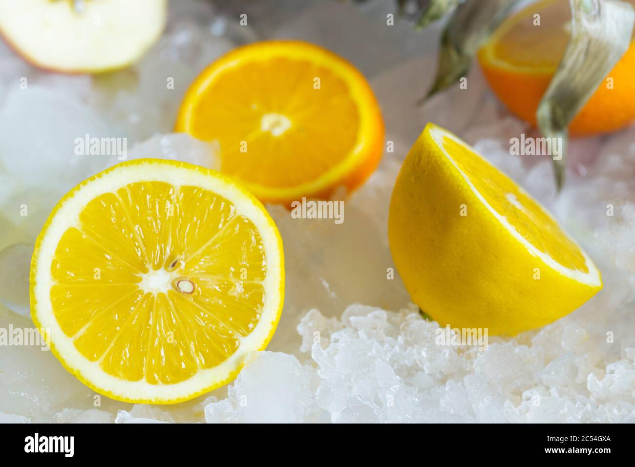 Lemons and orange lies on white ice Stock Photo