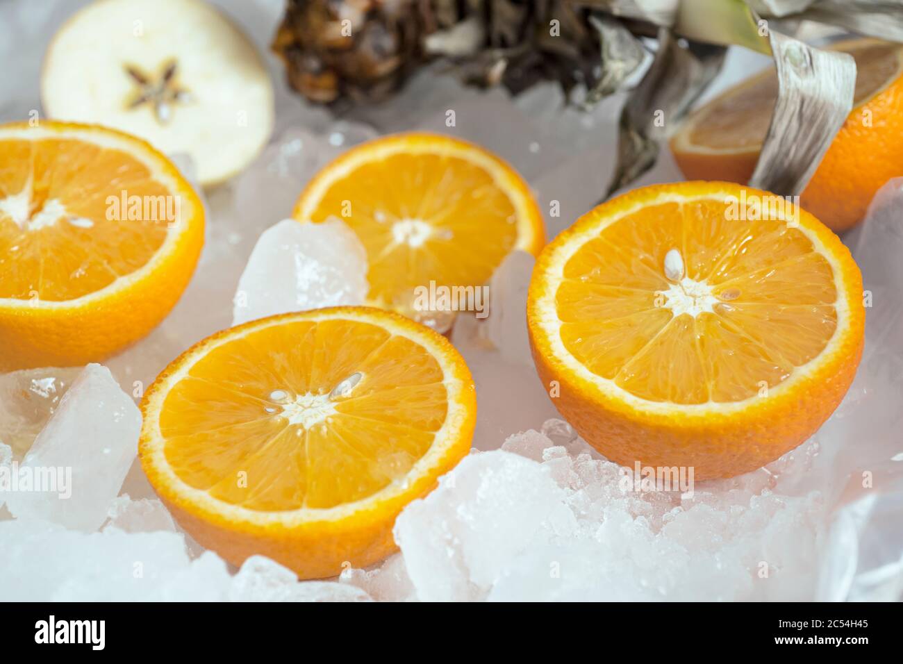 Lemons and orange lies on white ice Stock Photo
