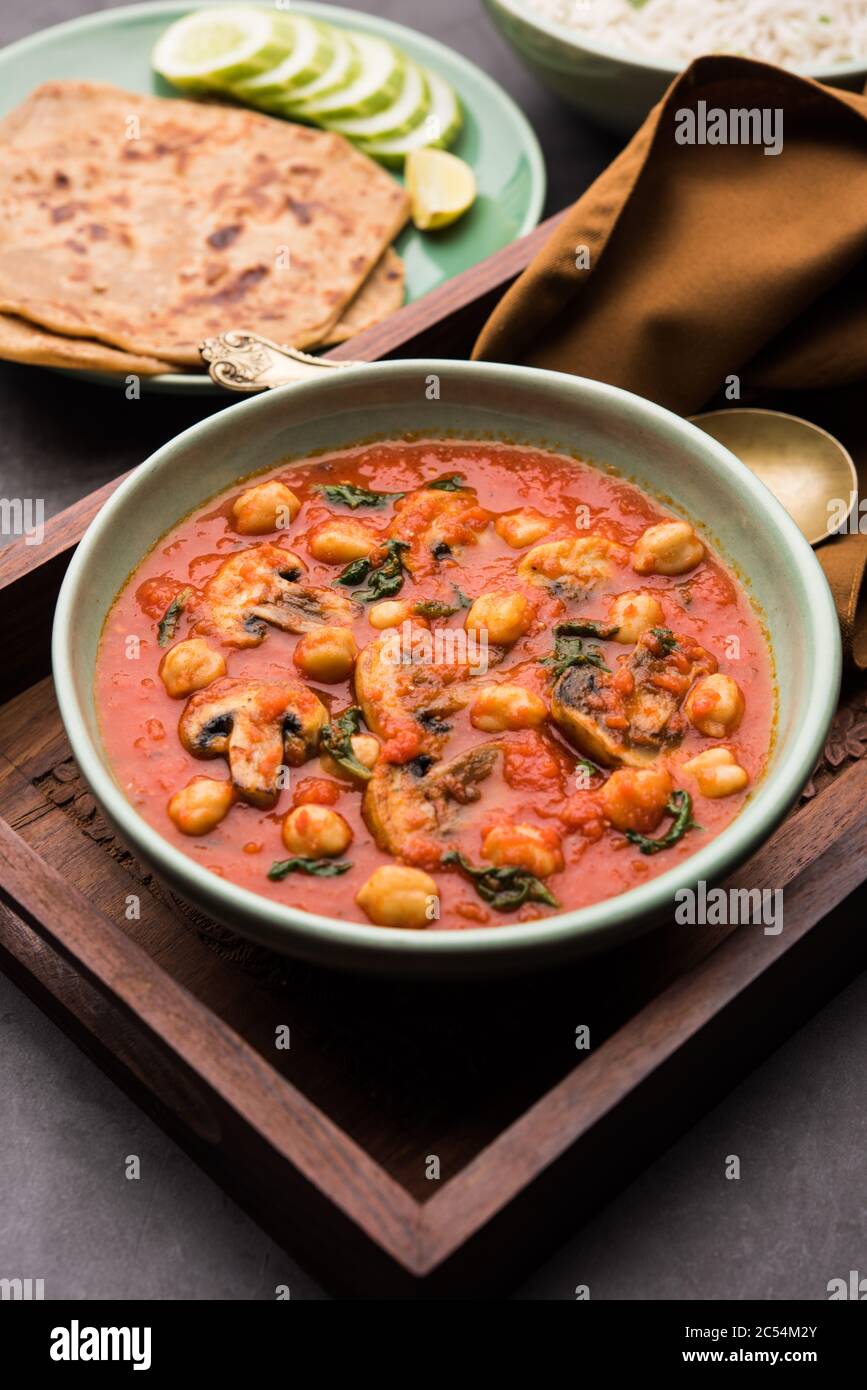 Mushroom sabzi in tomato curry with chickpea and spinach, Indian main
