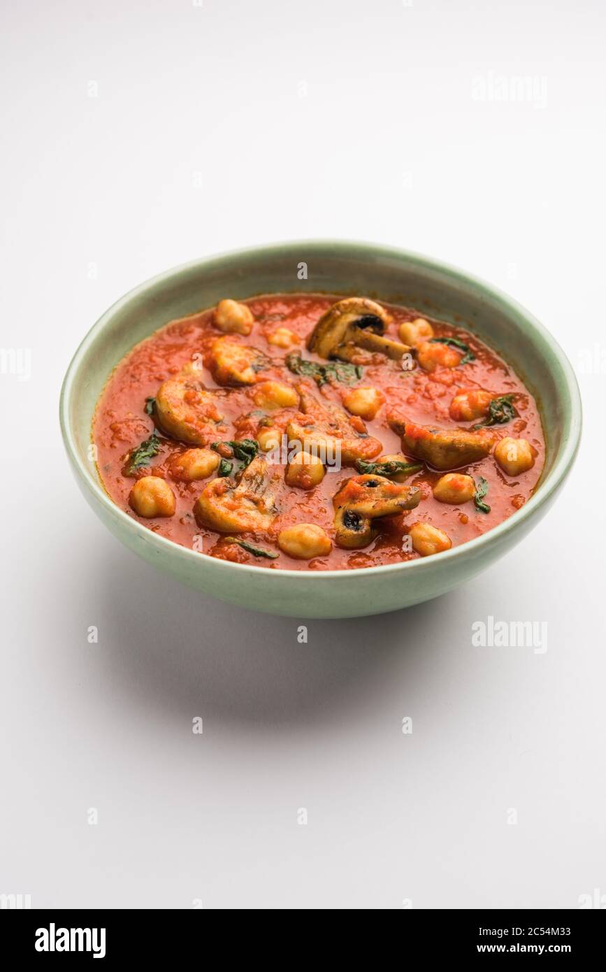 Mushroom sabzi in tomato curry with chickpea and spinach, Indian main