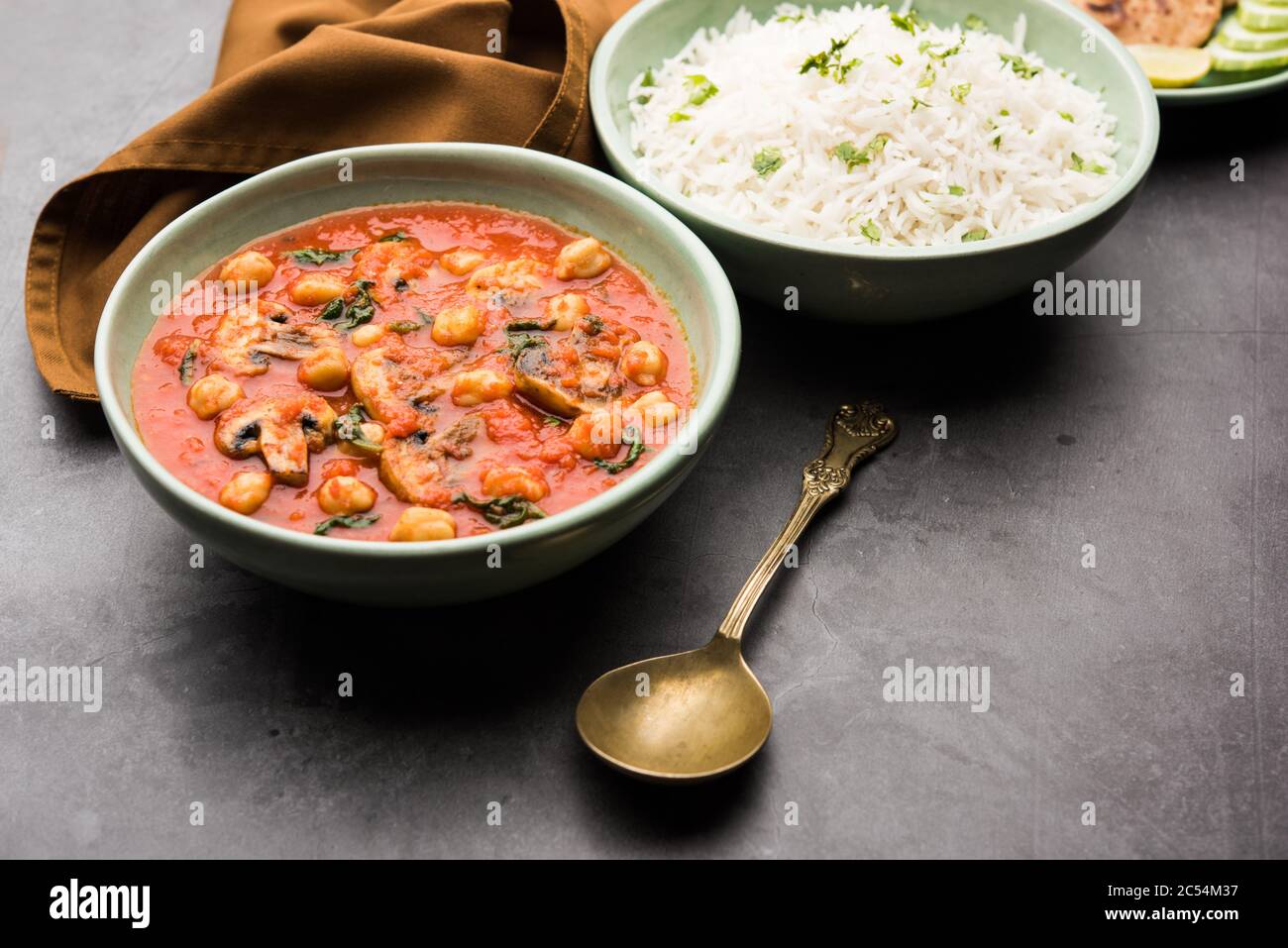 Mushroom sabzi in tomato curry with chickpea and spinach, Indian main