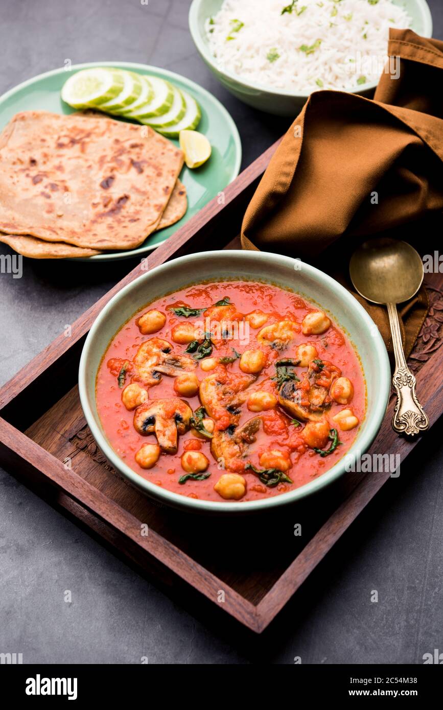 Mushroom sabzi in tomato curry with chickpea and spinach, Indian main ...