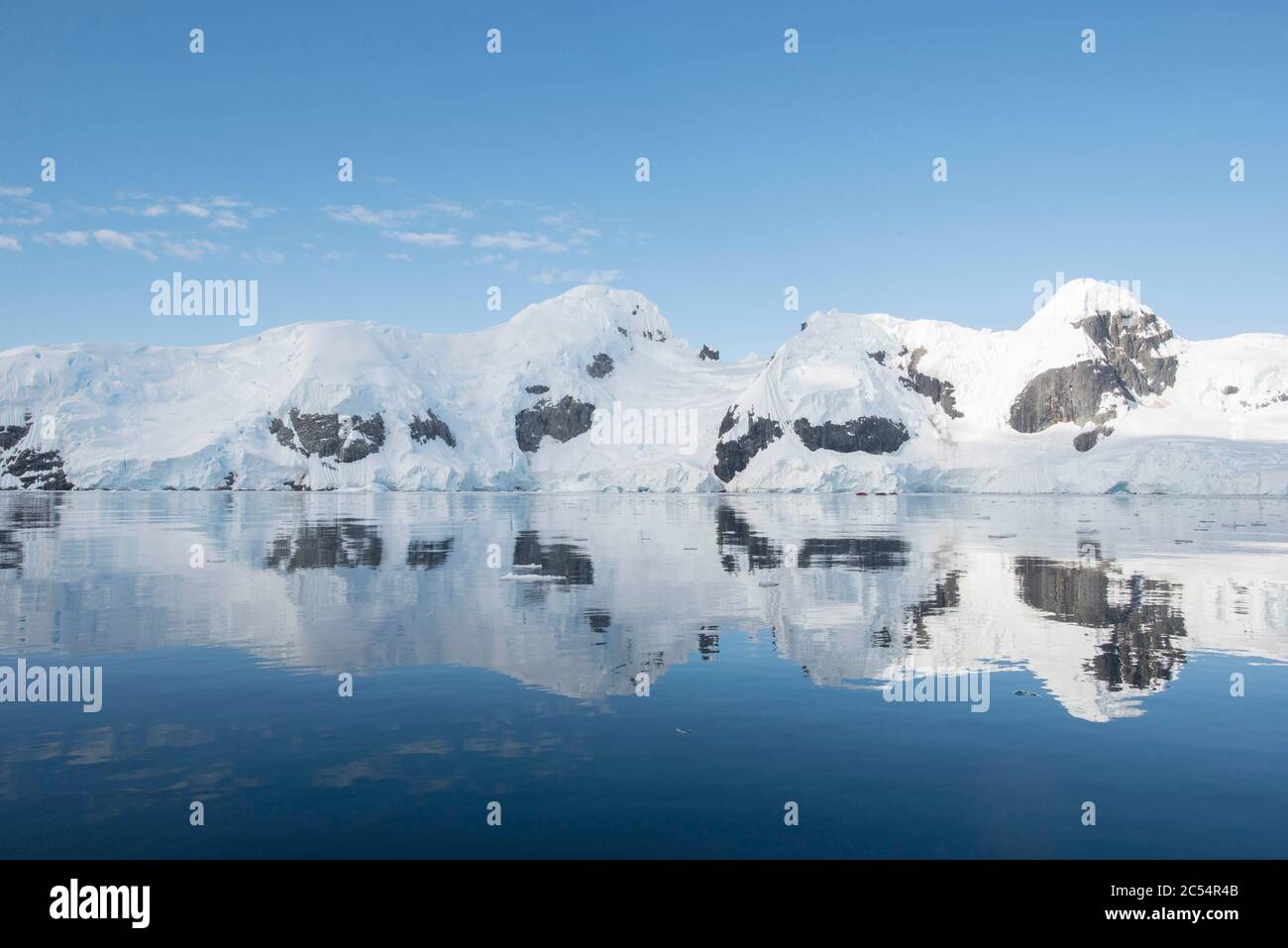 Reflections of ice covered mountains in Graham Passage Antarctica Stock Photo