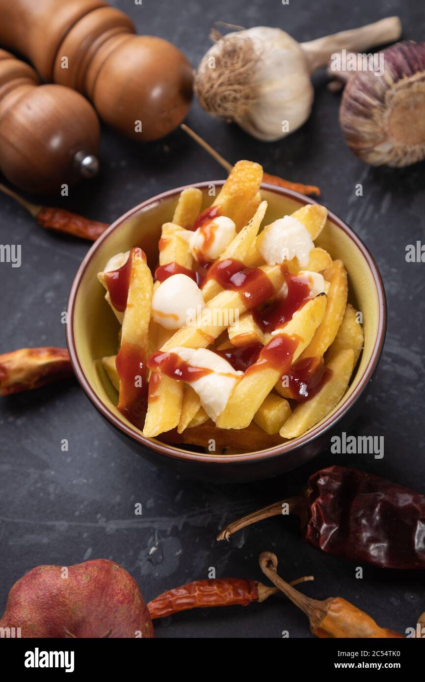 Canadian poutine, fried potato chips with cheese and gravy or sauce