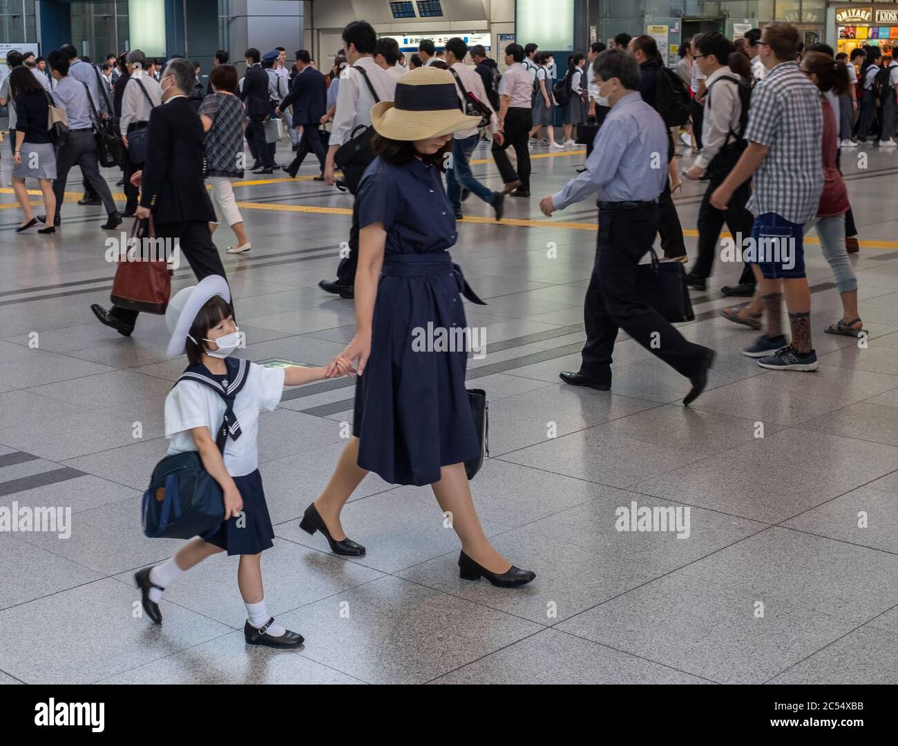 Japanese mother sending child to school in Shinagawa train stration, Tokyo, Japan Stock Photo