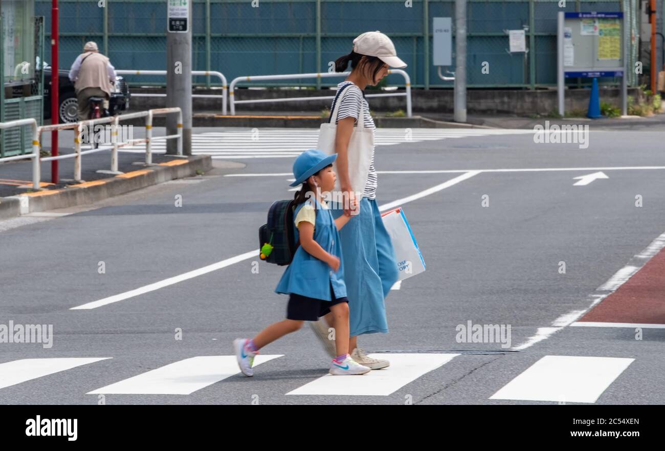 Japanese mother sending child to school in Shinagawa train stration, Tokyo, Japan Stock Photo