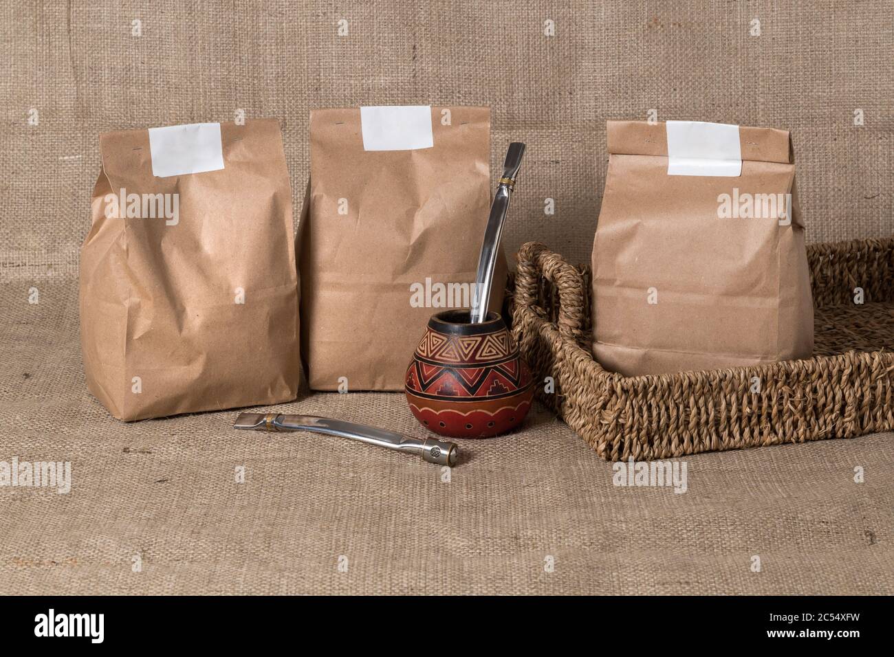 Packs for yerba made of kraft paper. Mate recipient with tube for sipping. Blank space for logo or name mockup. Stock Photo