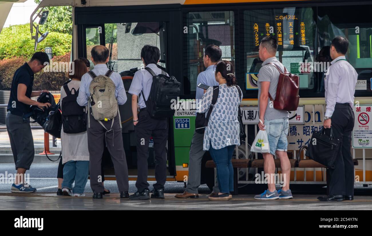 Office Workers Lining Up Waiting To Board A Bus At Shinagawa Station office-workers-lining-up-waiting-to-board-a-bus-at-shinagawa-station