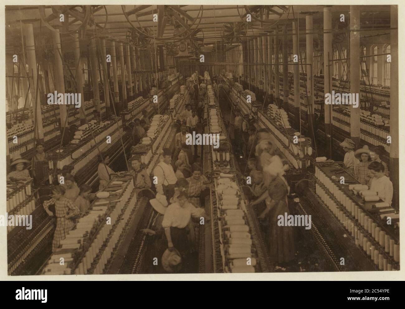 Interior of Magnolia (Miss.) Cotton Mills spinning room. See the little ones scattered through the mill. All work. See also other Magnolia photos and labels. Stock Photo