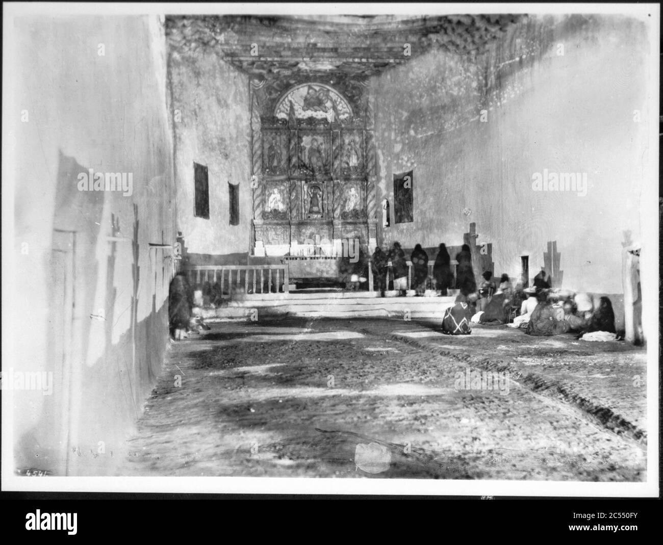 Interior of the old church during early morning mass at the Acoma Pueblo, New Mexico, 1886 Stock Photo