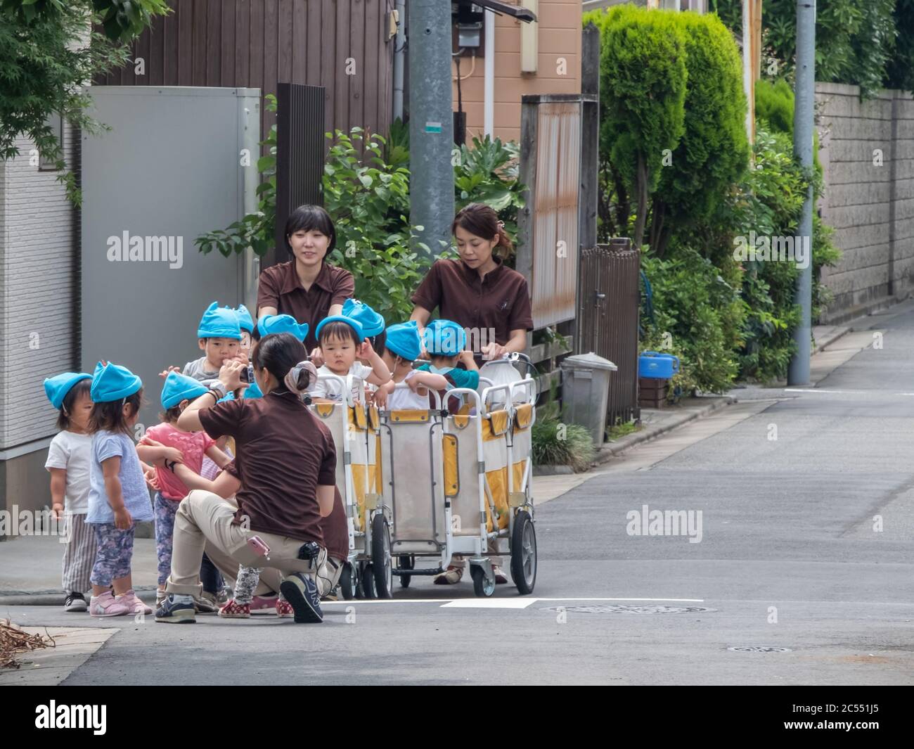 Japanese nursery babies in an outing at Kamimeguro street, Tokyo, Japan. Stock Photo