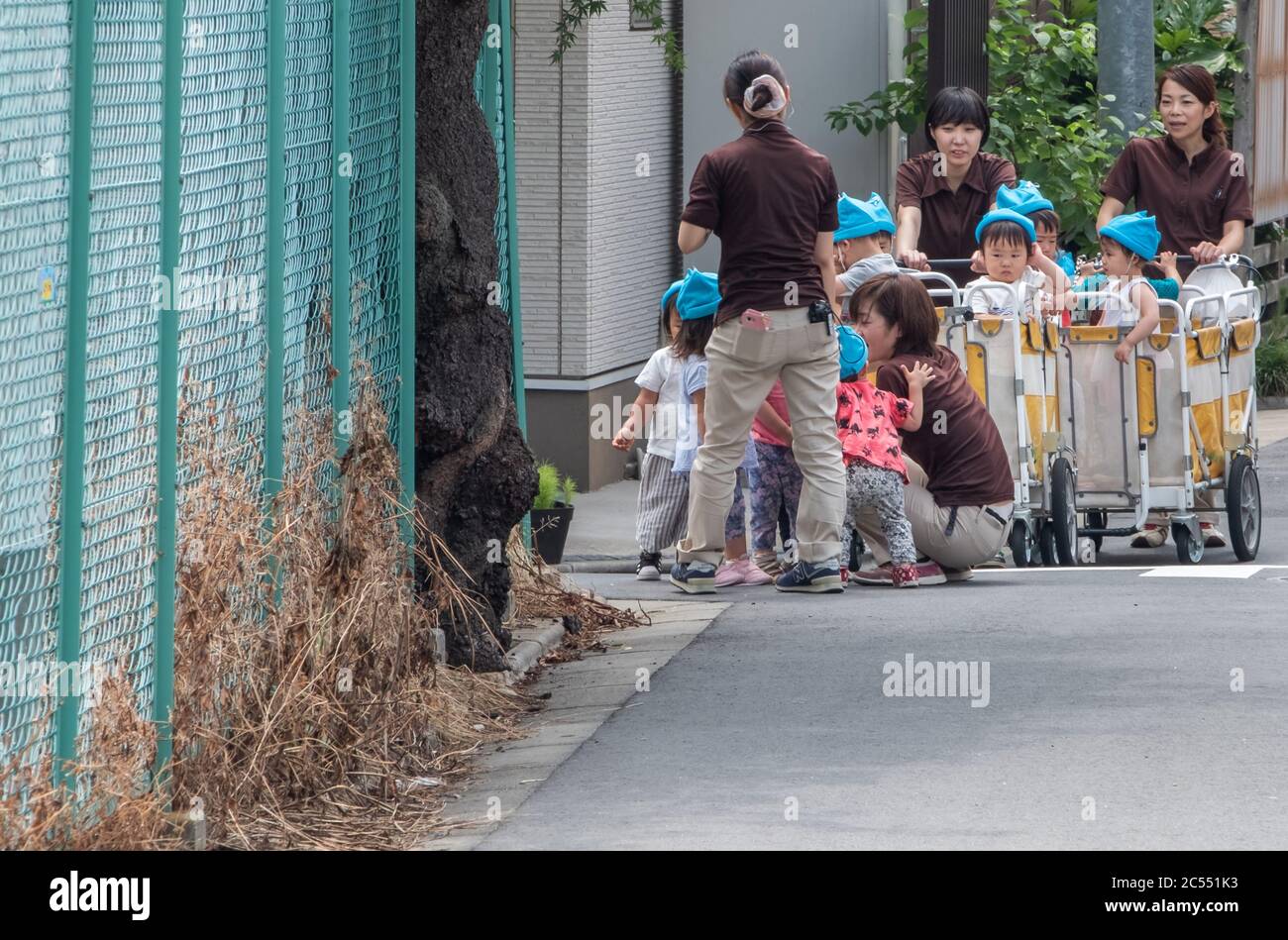 Japanese nursery babies in an outing at Kamimeguro street, Tokyo, Japan. Stock Photo