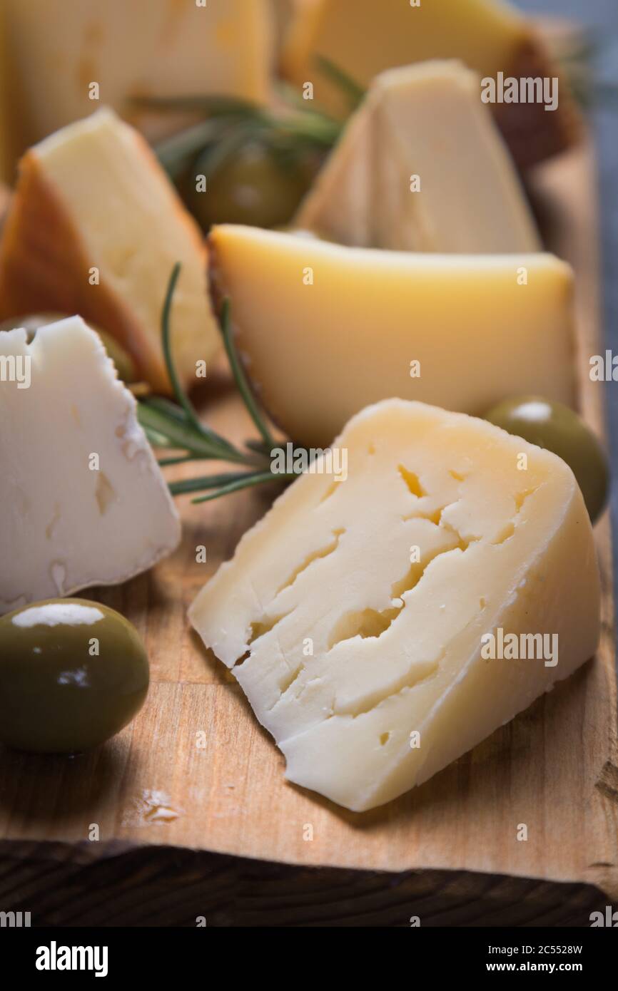 Cheese platter with blue, aged, yellow and white cheeses Stock Photo