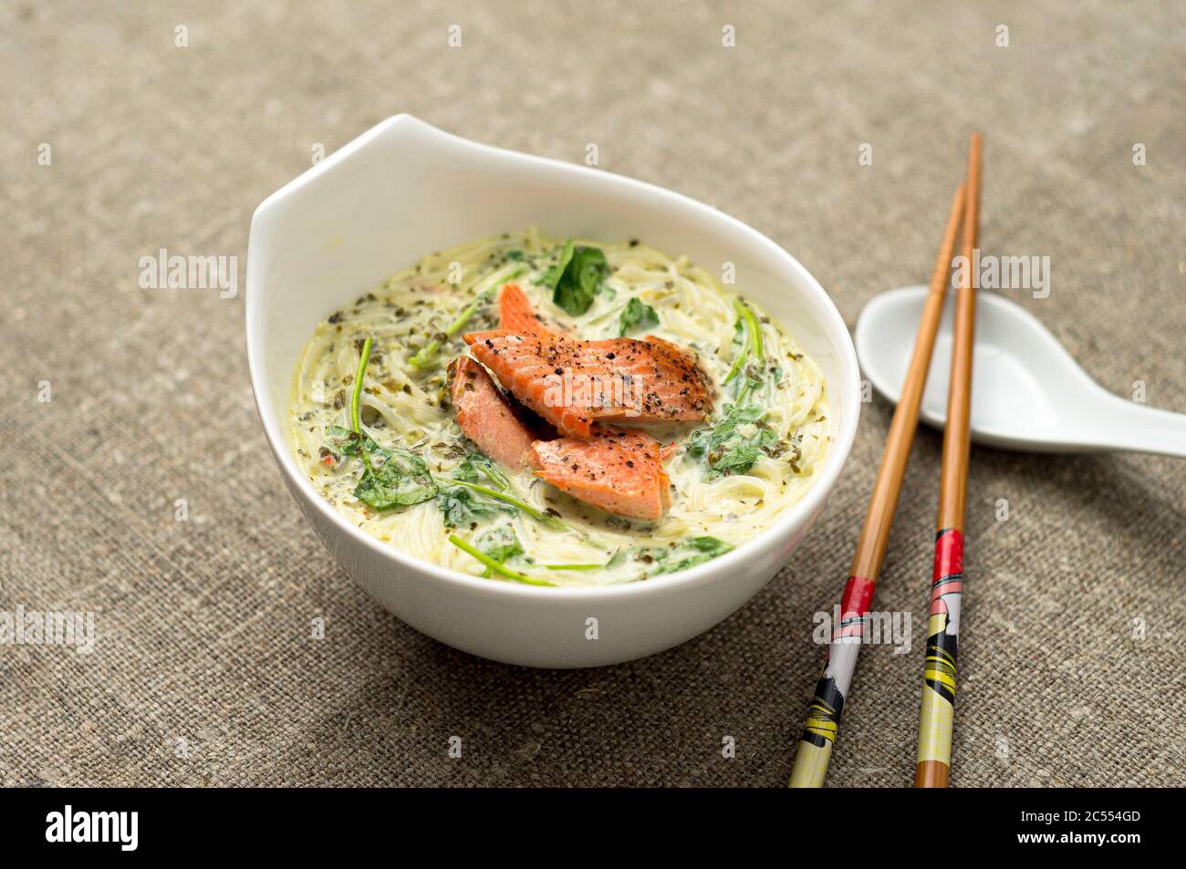Tasty thai coconut soup with noodles. One of the most popular Thai food, tom kha is a spicy and sour soup with coconut milk. Vermicelli noodles and sa Stock Photo