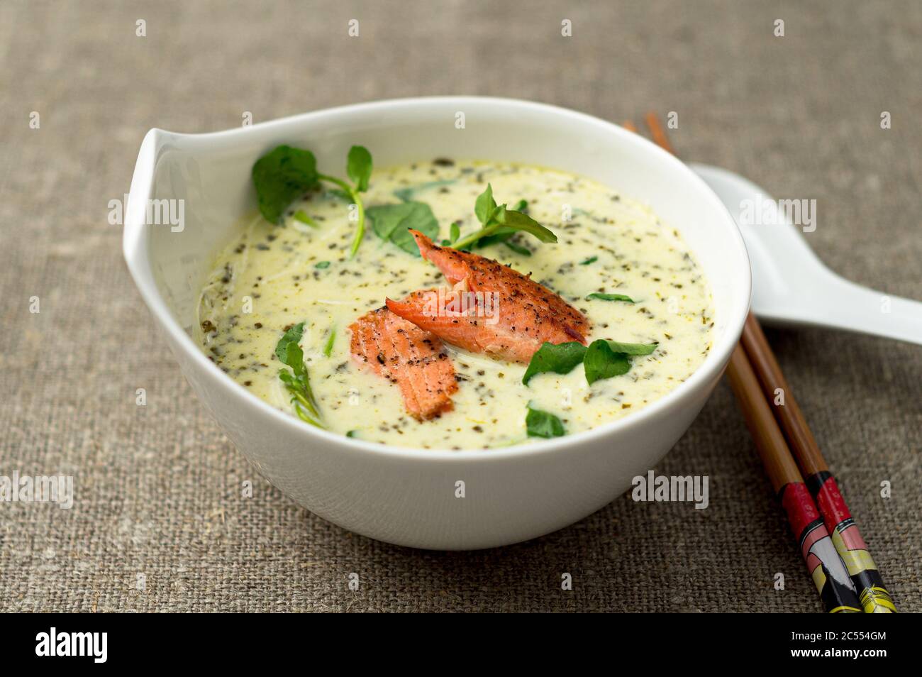 Tom kha asian coconut soup bowl. One of the most popular Thai food, tom kha is a spicy and sour soup with coconut milk. Vermicelli noodles and salmon Stock Photo