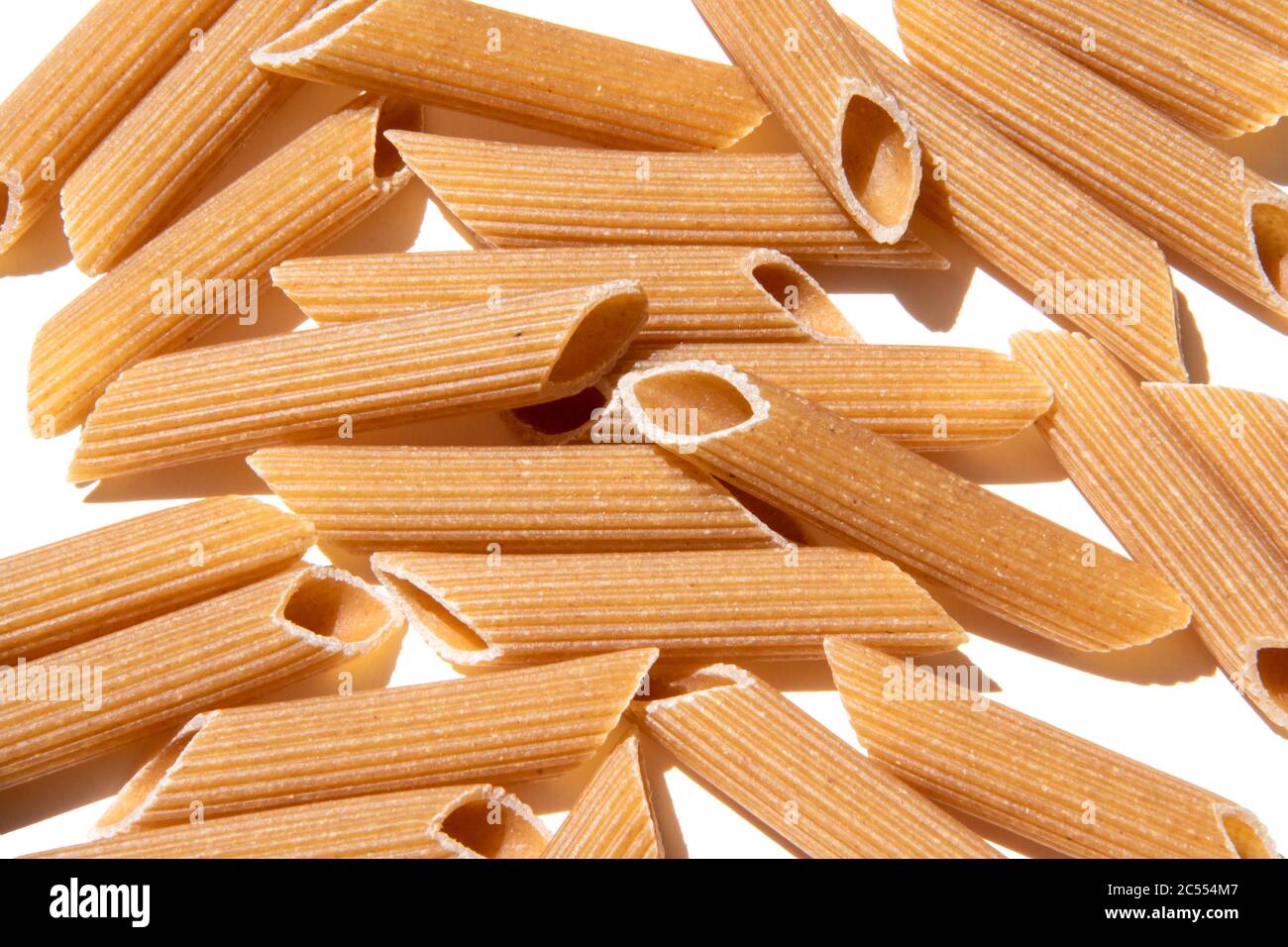 Pasta penne background wallpaper. italian food whole grain lunch ingredient. healthy eating full of carbohydrate. raw grain mediterranean food. Pile o Stock Photo