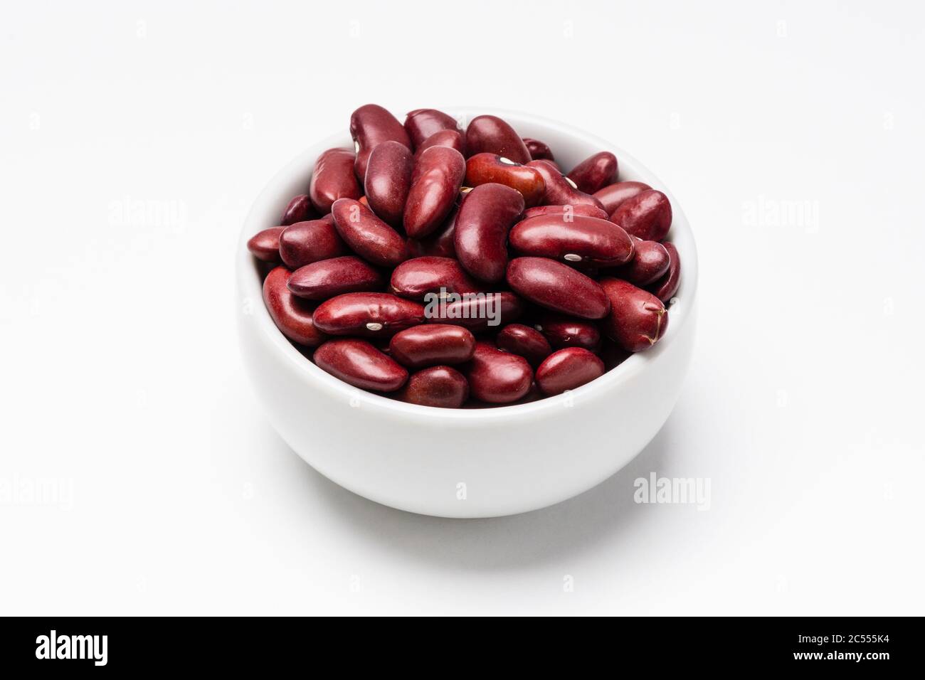 Red kidney beans bowl on white background. These uncooked red kidney
