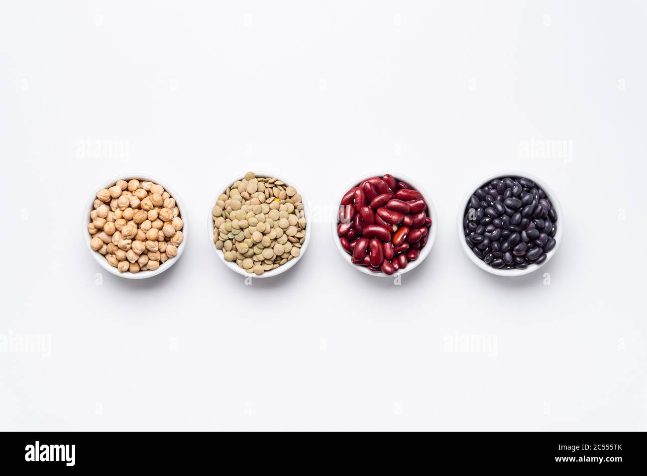 Bean bowls top view white background. These legumes are all pulses (dry