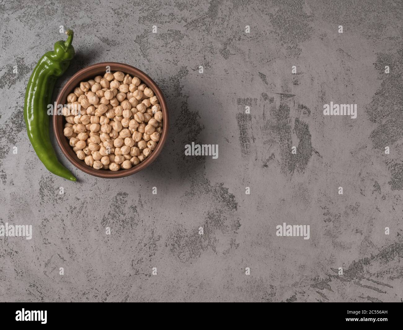 Chickpeas in a bowl and selenay chilli. The gray background. Stock Photo