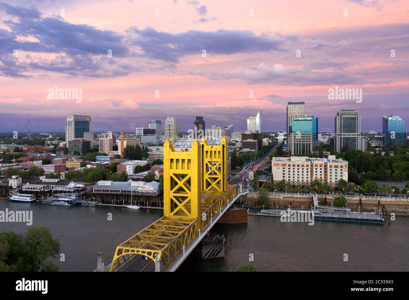 Aerial view of a pink sunset sky over downtown Sacramento, the river and the gold colored Tower Bridge Stock Photo