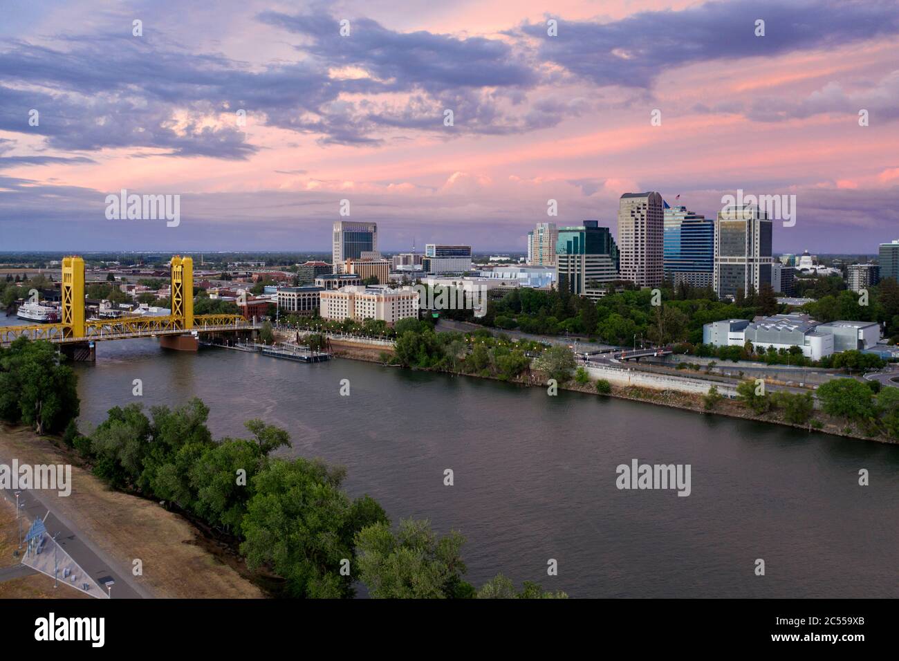 Aerial view of a pink sunset sky over downtown Sacramento, the river and the gold colored Tower Bridge Stock Photo