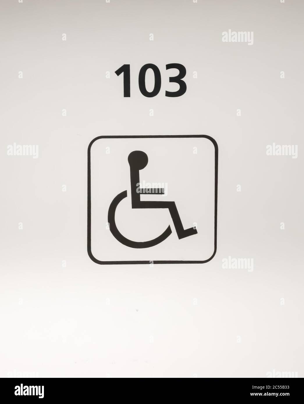 Parking lot with painted sign of wheelchair. Parking spaces for disabled customers. Stock Photo