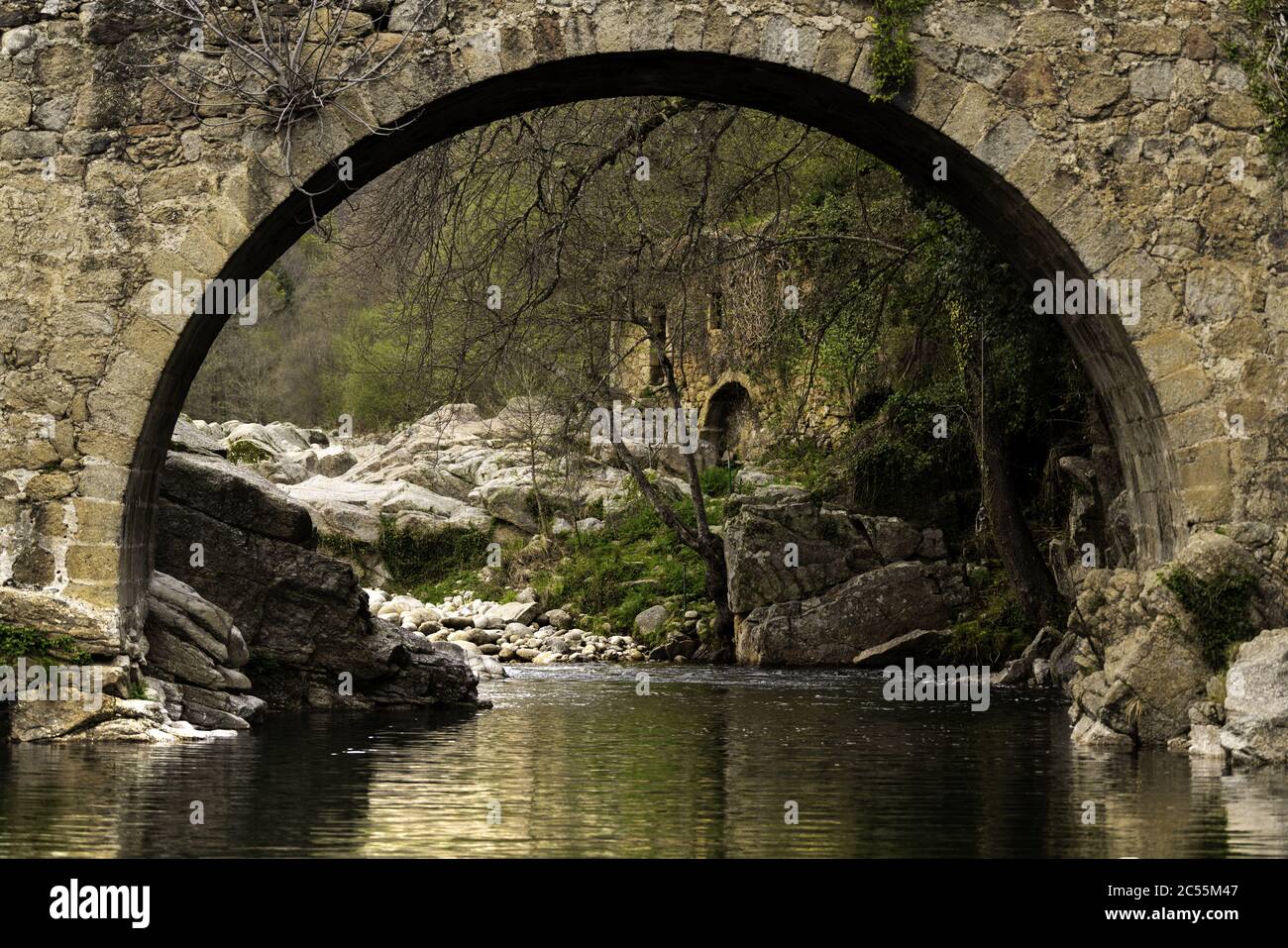 Amazing shot of a flowing river and an old stone bridge Stock Photo - Alamy