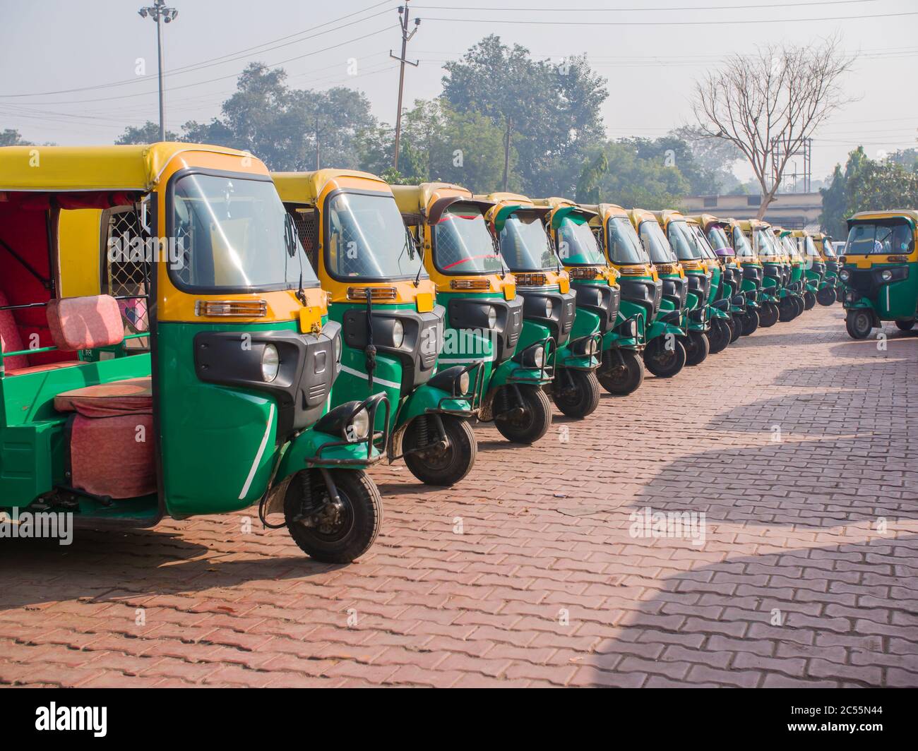 Yellow and green auto rickshaws in Indiya. Stock Photo