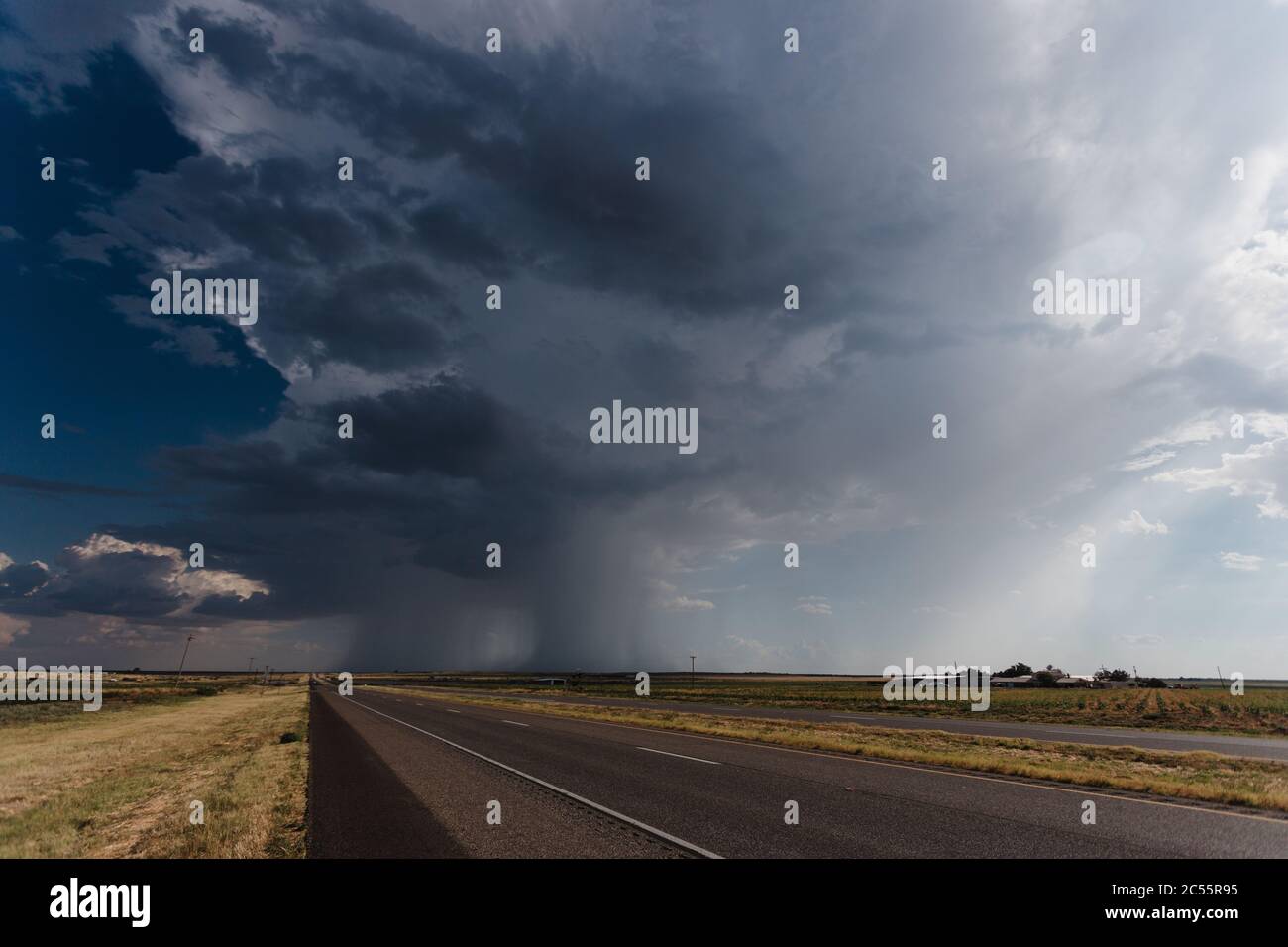 Long asphalt road under the cloudy rainy sky Stock Photo - Alamy