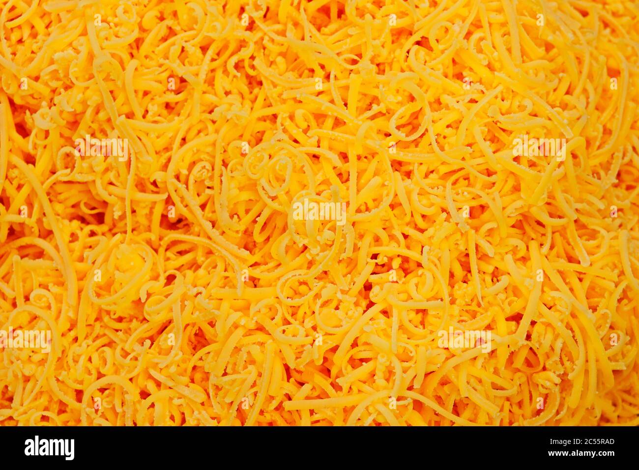 grated red cheddar cheese in close up Stock Photo Alamy