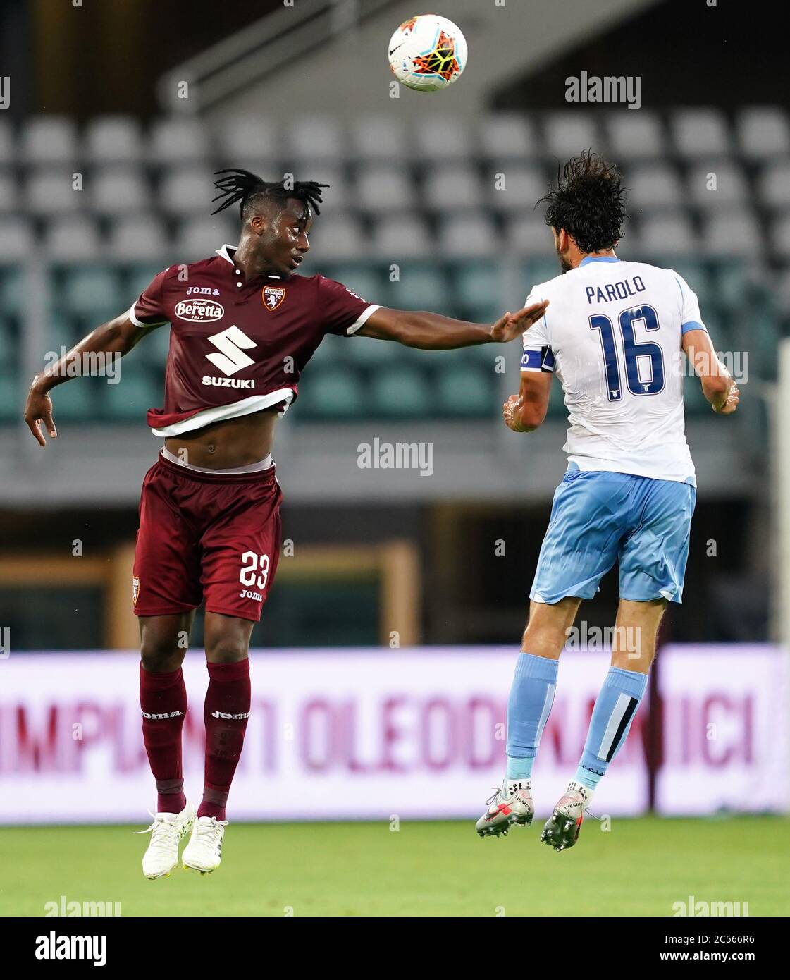 Turin. 1st July, 2020. Torino's Soualiho Meite (L) vies with Lazio's Marco Parolo during a Serie A football match between Torino and Lazio in Turin, Italy, June 30, 2020. Credit: Xinhua/Alamy Live News Stock Photo
