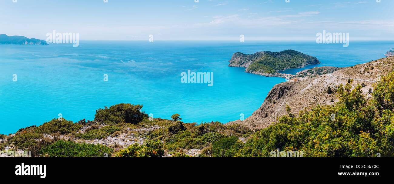 Panoramic shot of Frourio peninsula with cute Assos village surrounded by beautiful blue sea. Kefalonia island, Greece. Stock Photo