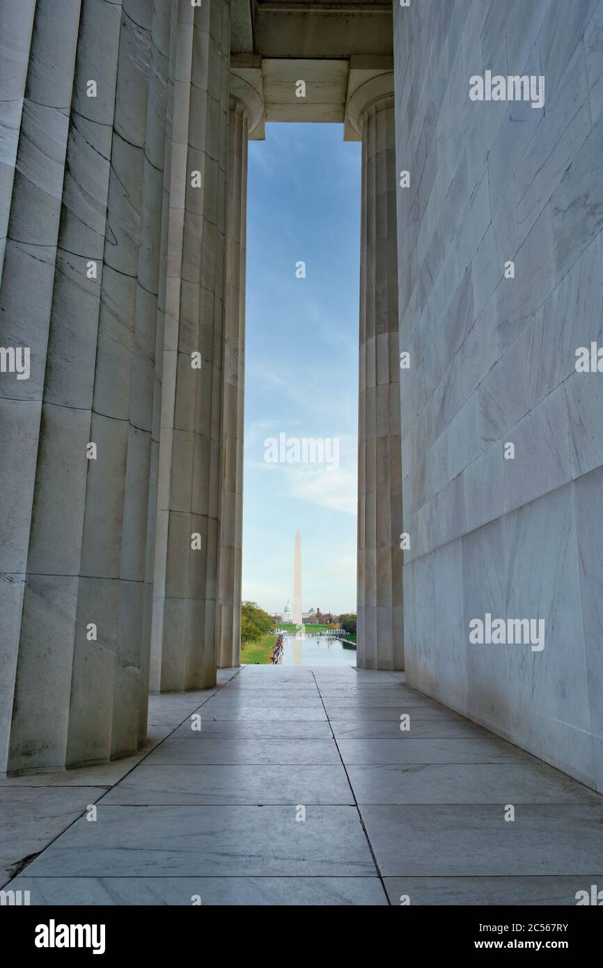 The Washington Monument, Reflecting Pool and large number of tourists can be seen between Lincoln Memorial's columns, Washington, DC, USA Stock Photo