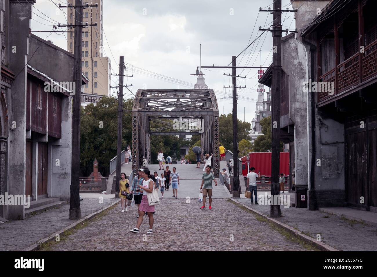 Tourists walk around the set of a Chinese period drama. Actors and