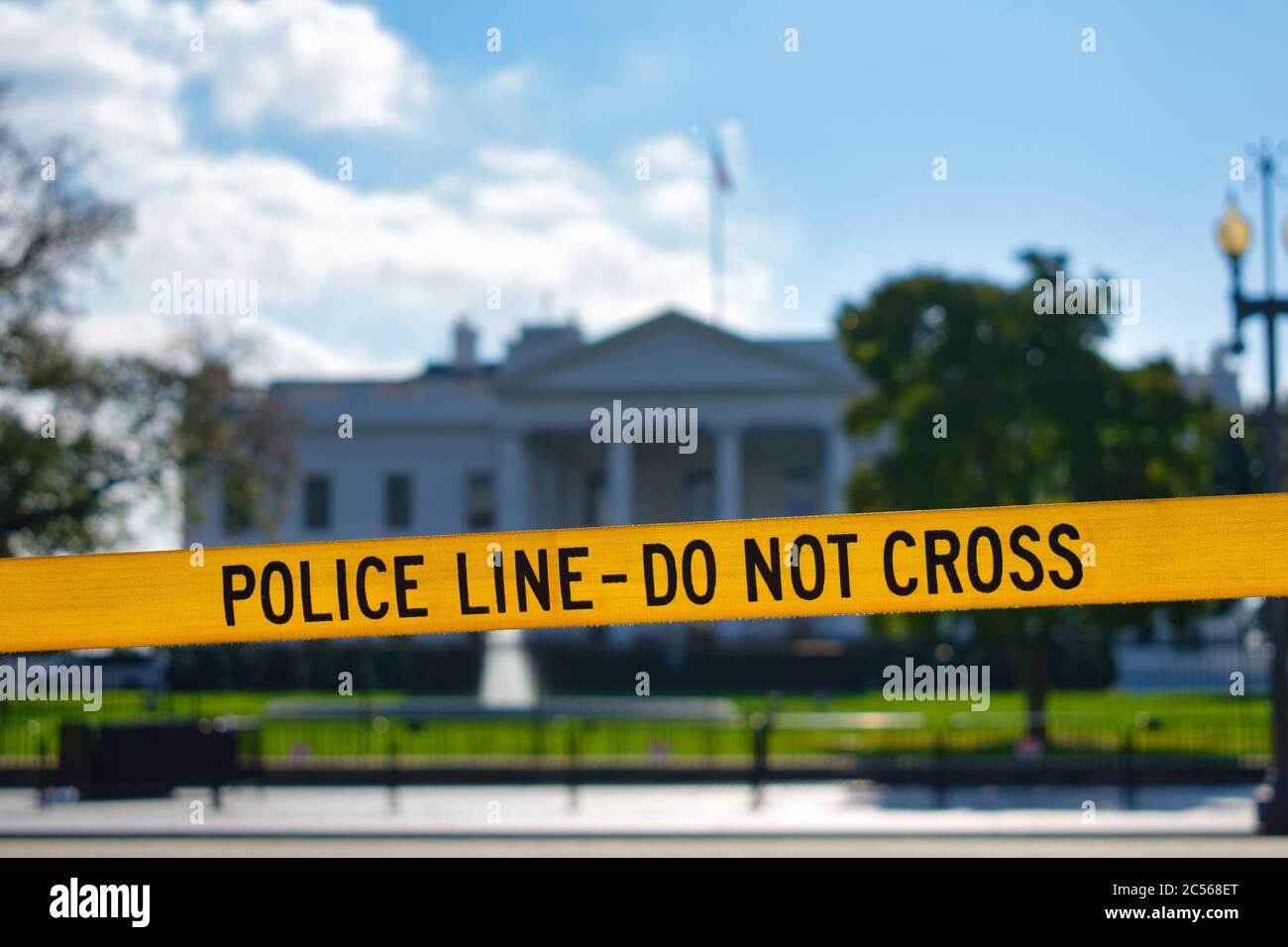 Yellow POLICE LINE - DO NOT CROSS barricade tape in front of the White House, Washington, DC, USA Stock Photo