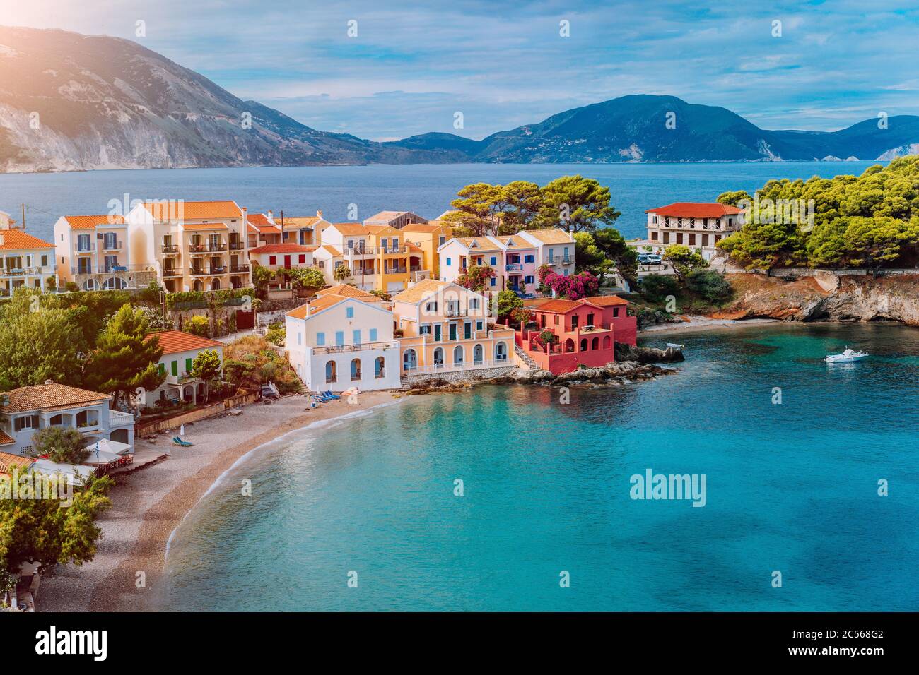 Turquoise colored bay in Mediterranean sea with beautiful colorful houses  in Assos village in Kefalonia, Greece. Town of Assos with colorful houses  on Stock Photo - Alamy