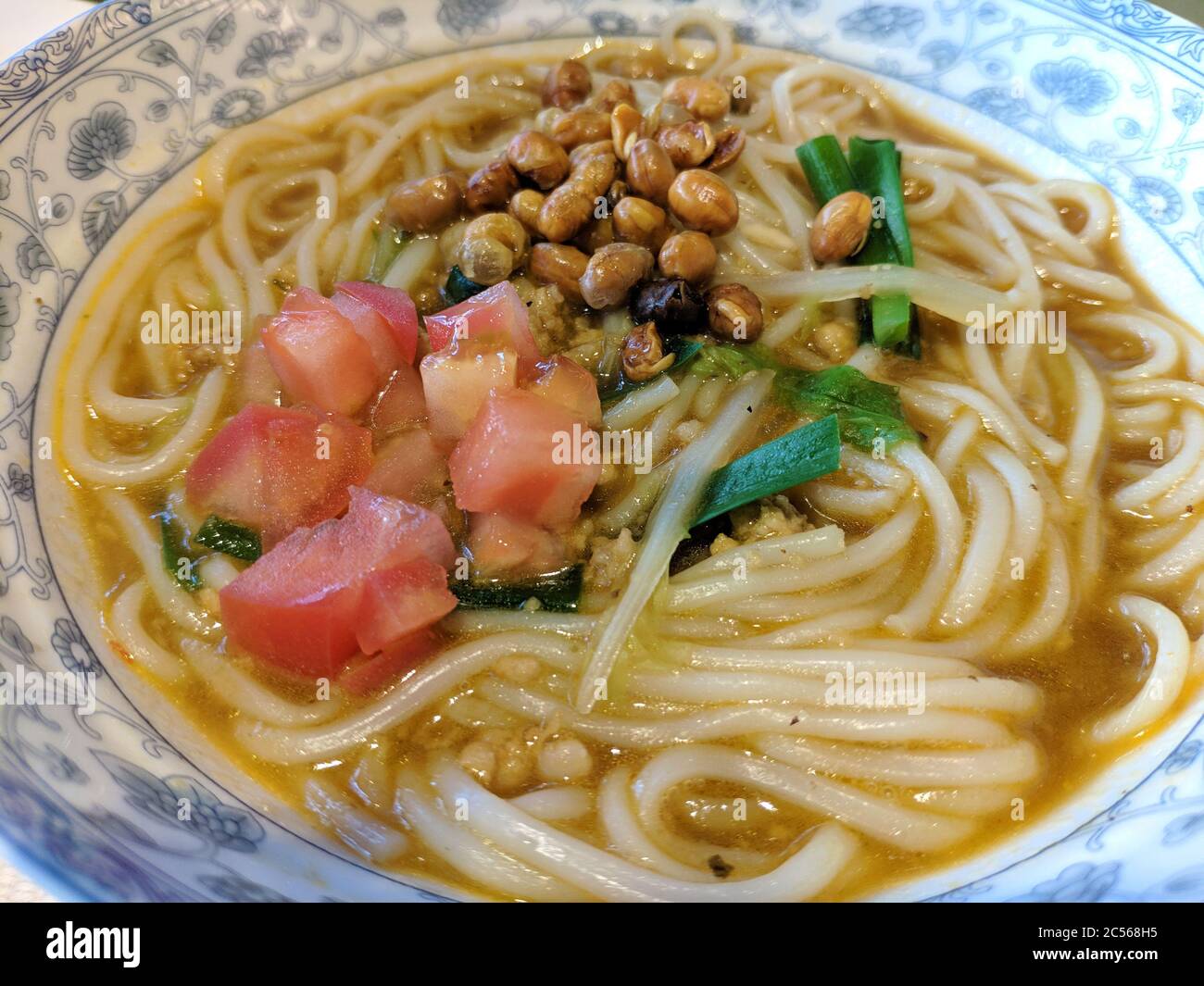 Chinese traditional rice noodles with peanuts and tomatoes as breakfast