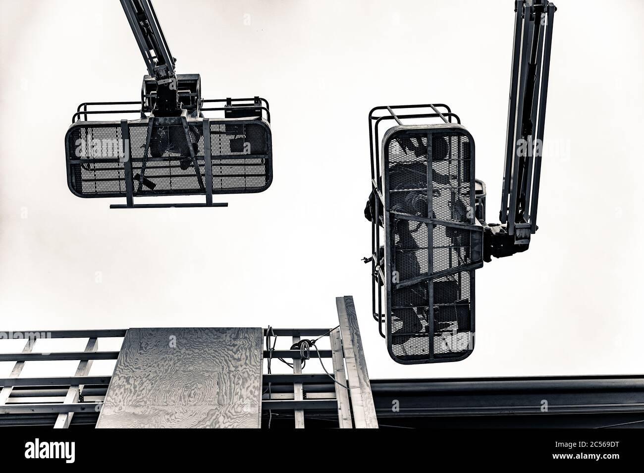 Low angle grey scale shot of mobile moving cranes Stock Photo - Alamy