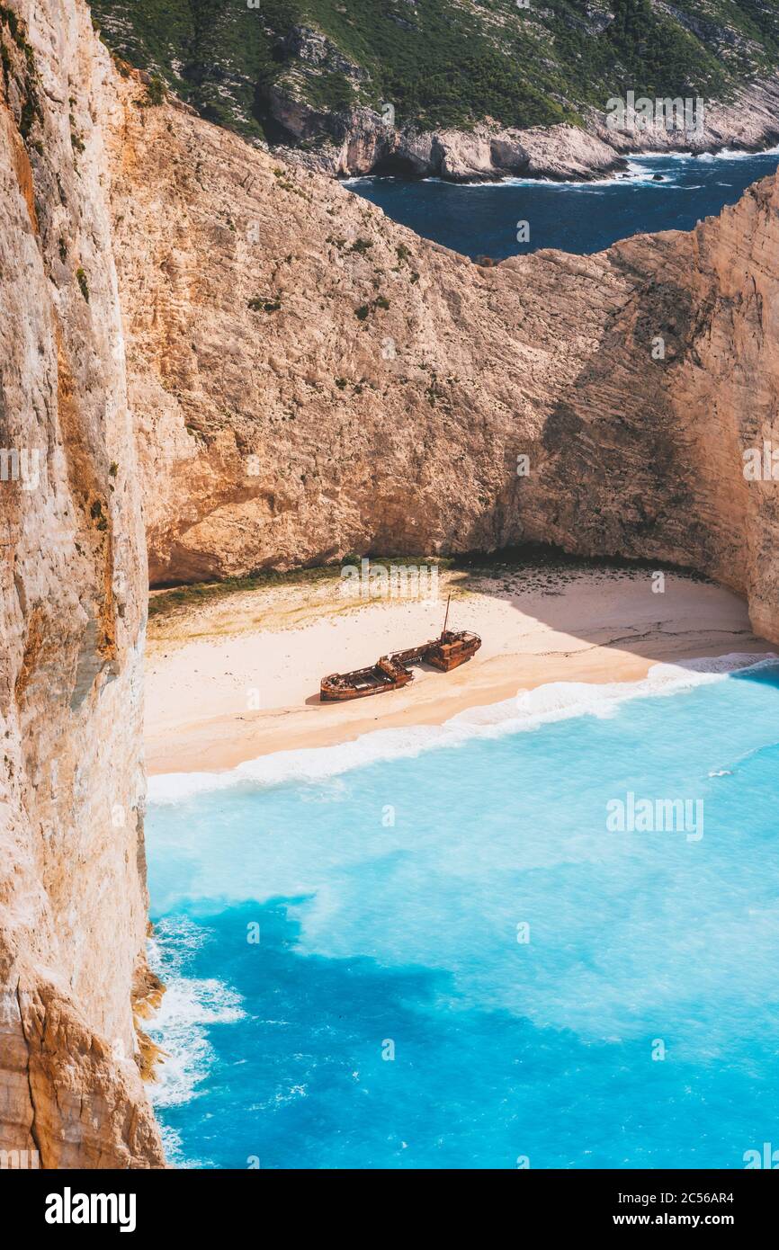 Zakynthos island, Greece. Famous Navagio beach with shipwreck in hot summer day. Turquoise water and pebble beach surrounded by limestone walls. Stock Photo