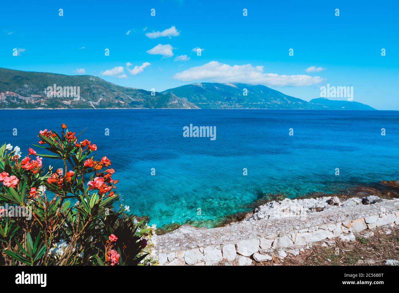 Panorama of crystal clear transparent blue turquoise teal Mediterranean seascape in Fiskardo town. Kefalonia, Ionian islands, Greece. Stock Photo