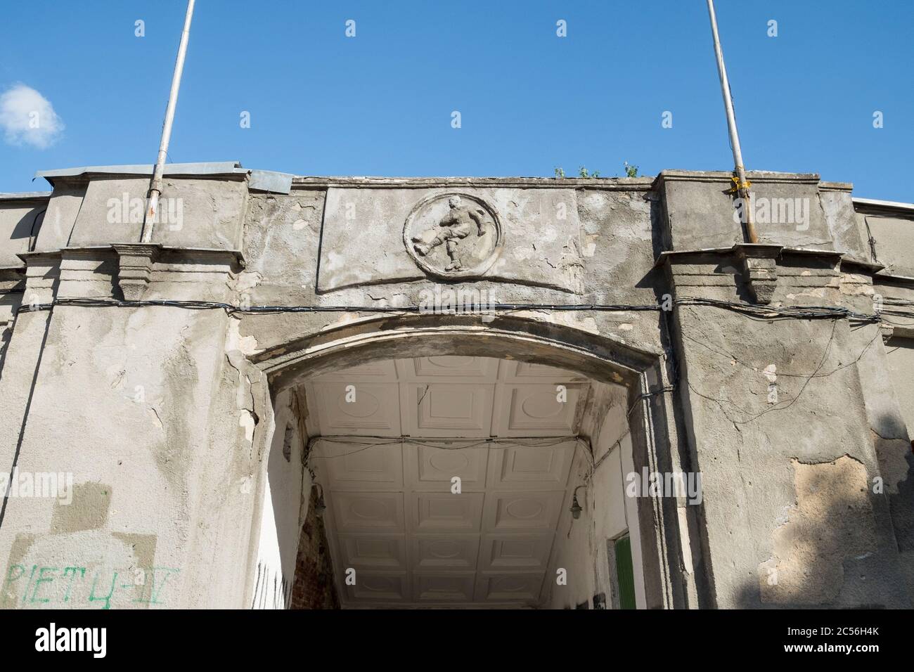 A football, soccer player round frieze above a gate to Žalgiris Stadium, now torn down. In Vilnius, Lithuania. Stock Photo